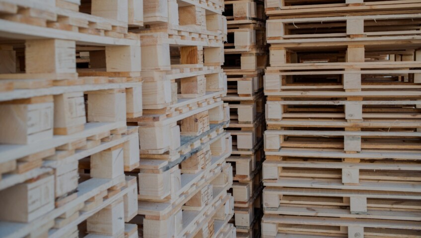 Stacks of wooden pallets prepared for shipping and logistics